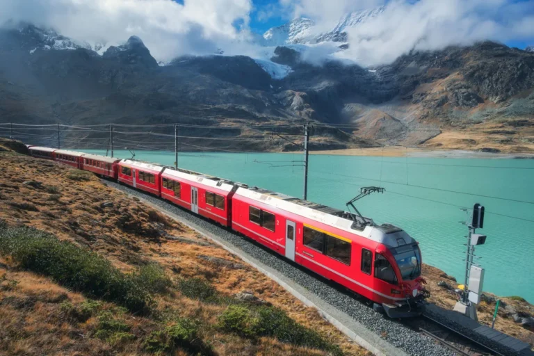 red-train-is-moving-along-railway-in-swiss-alps-mo-2025-03-18-21-28-42-utc2